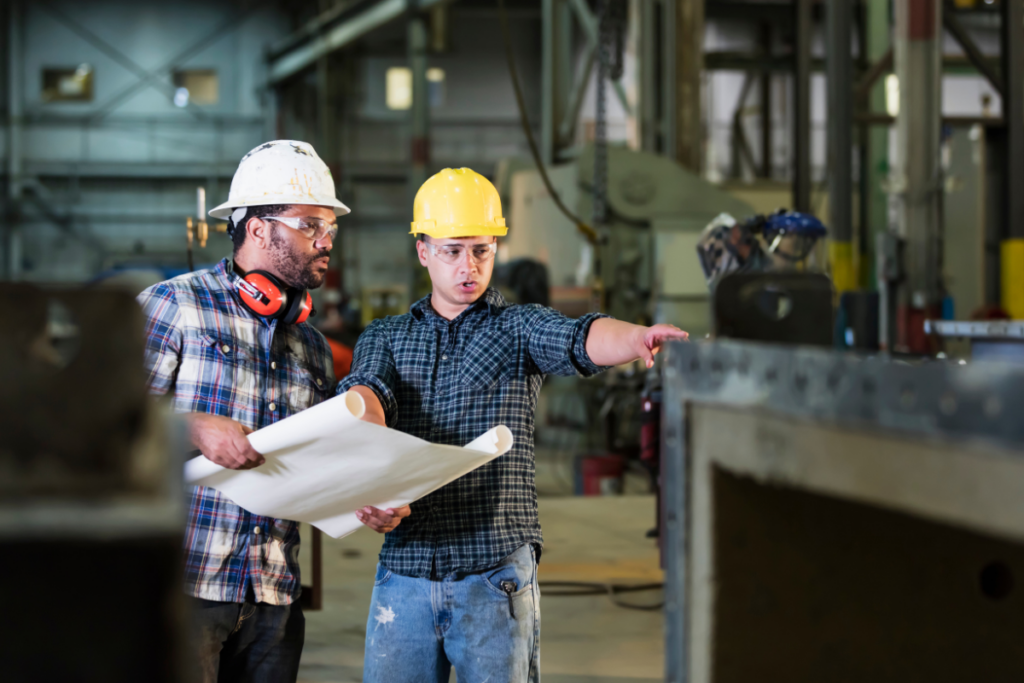 Two People Discussing Safety in the metal fabrication workplace - AC Fabrication And Assembly Solutions