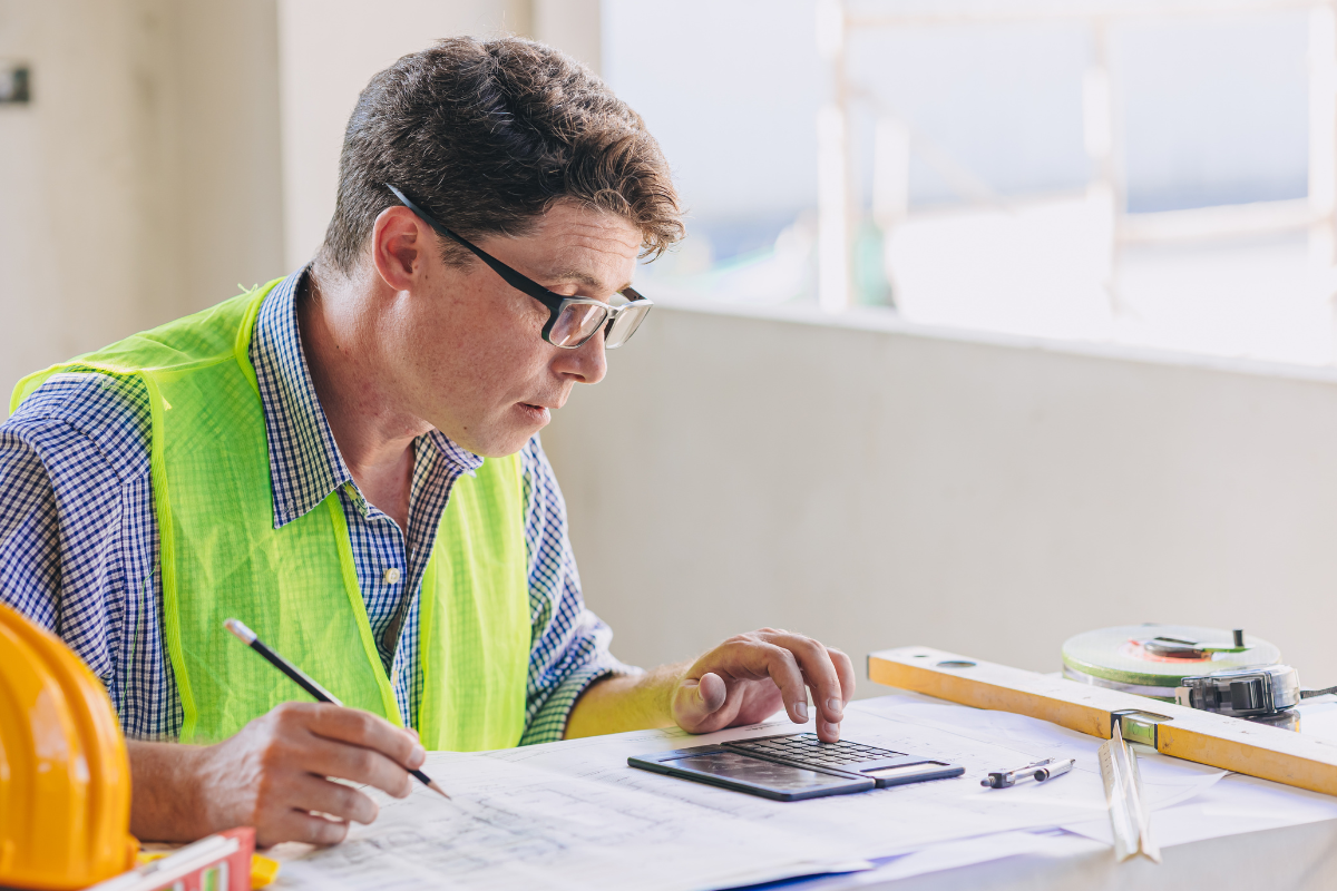 A Metalworker Calculating Costs - AC Fabrication And Assembly Solutions