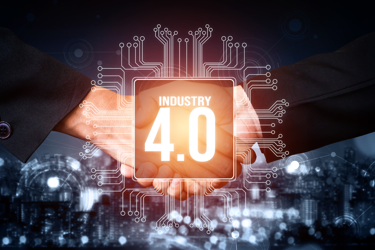 Two Hands Shaking Over An Industry 4.0 Logo - AC Fabrication And Assembly Solutions